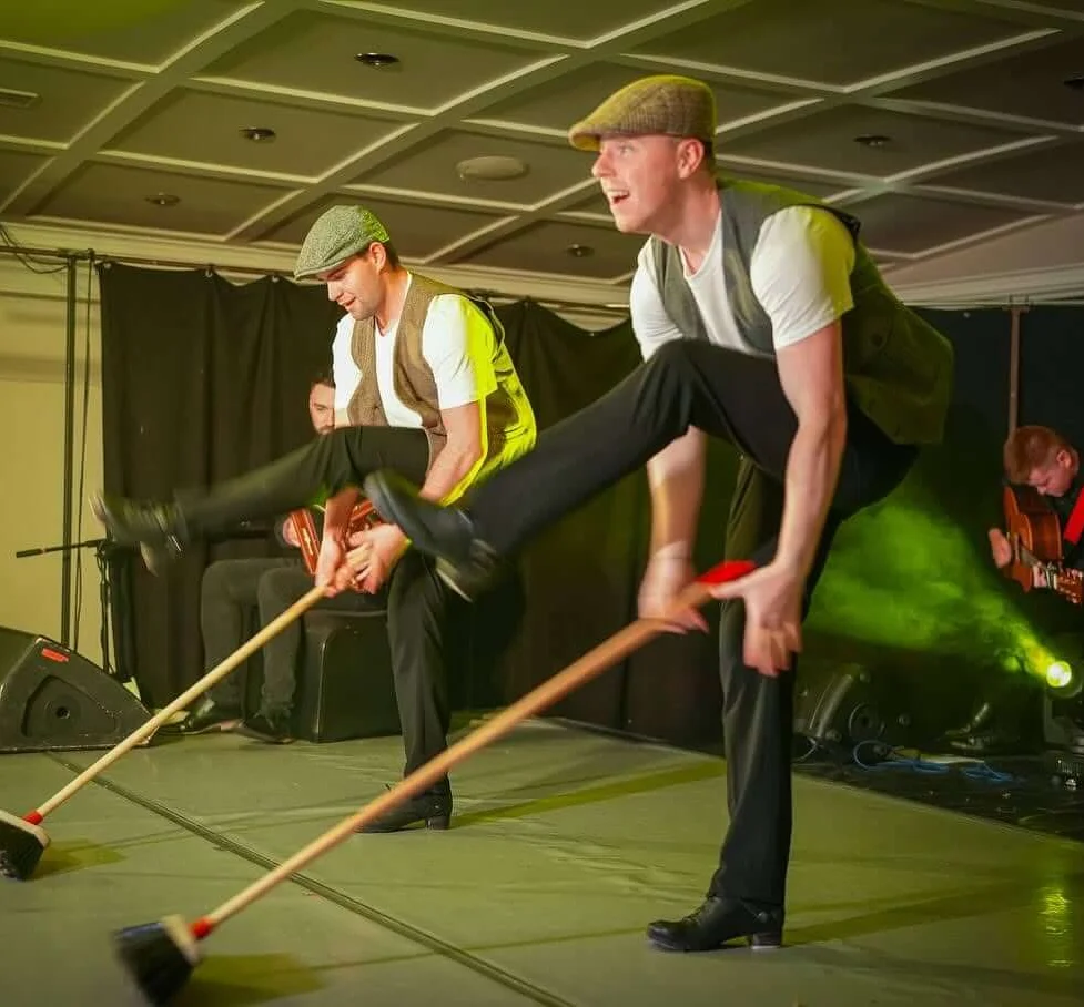 Lively traditional performance at the hotel with dancers in caps and vests, creating a vibrant atmosphere.