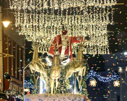Festive street display with Santa, reindeer, and sparkling lights creating a magical holiday atmosphere.